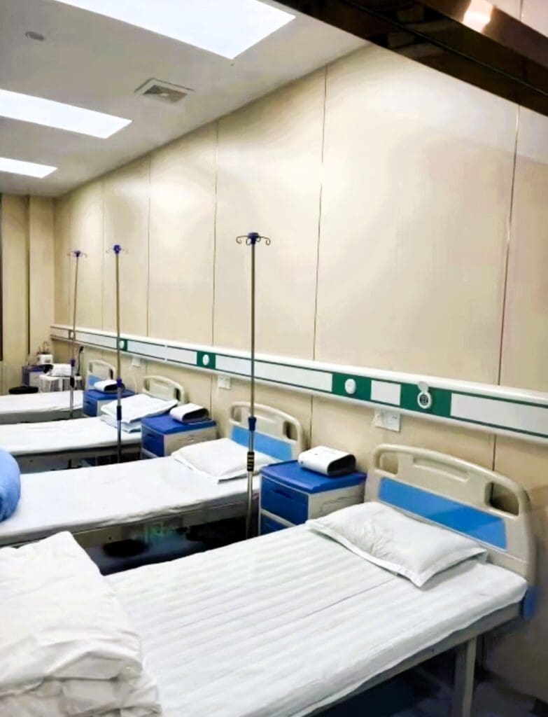 Hospital room with empty beds and equipment.