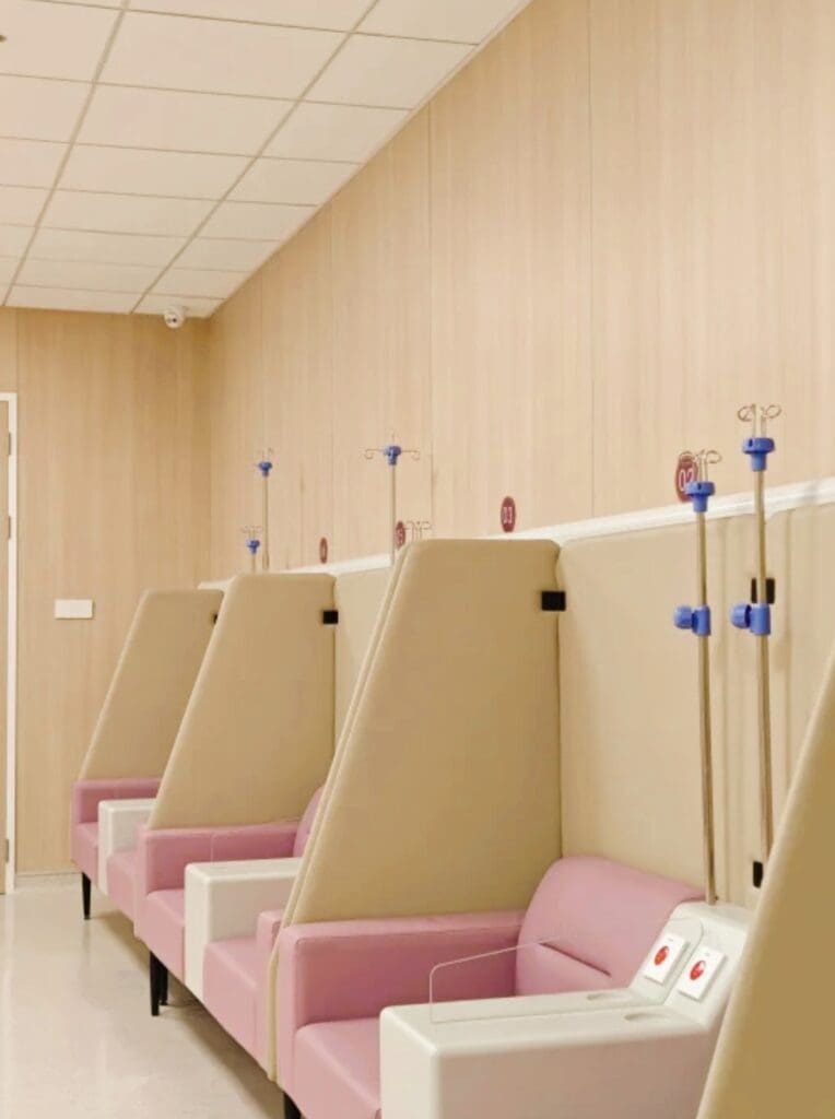 Hospital room with pink patient chairs.