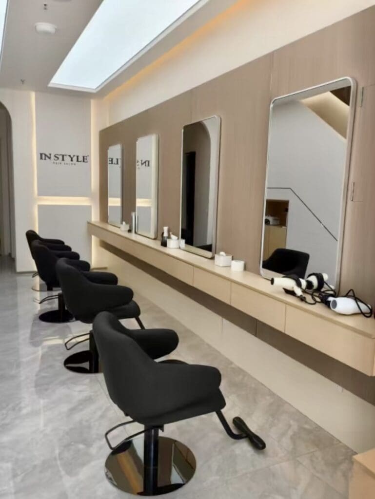 Modern hair salon with styling chairs and mirrors.