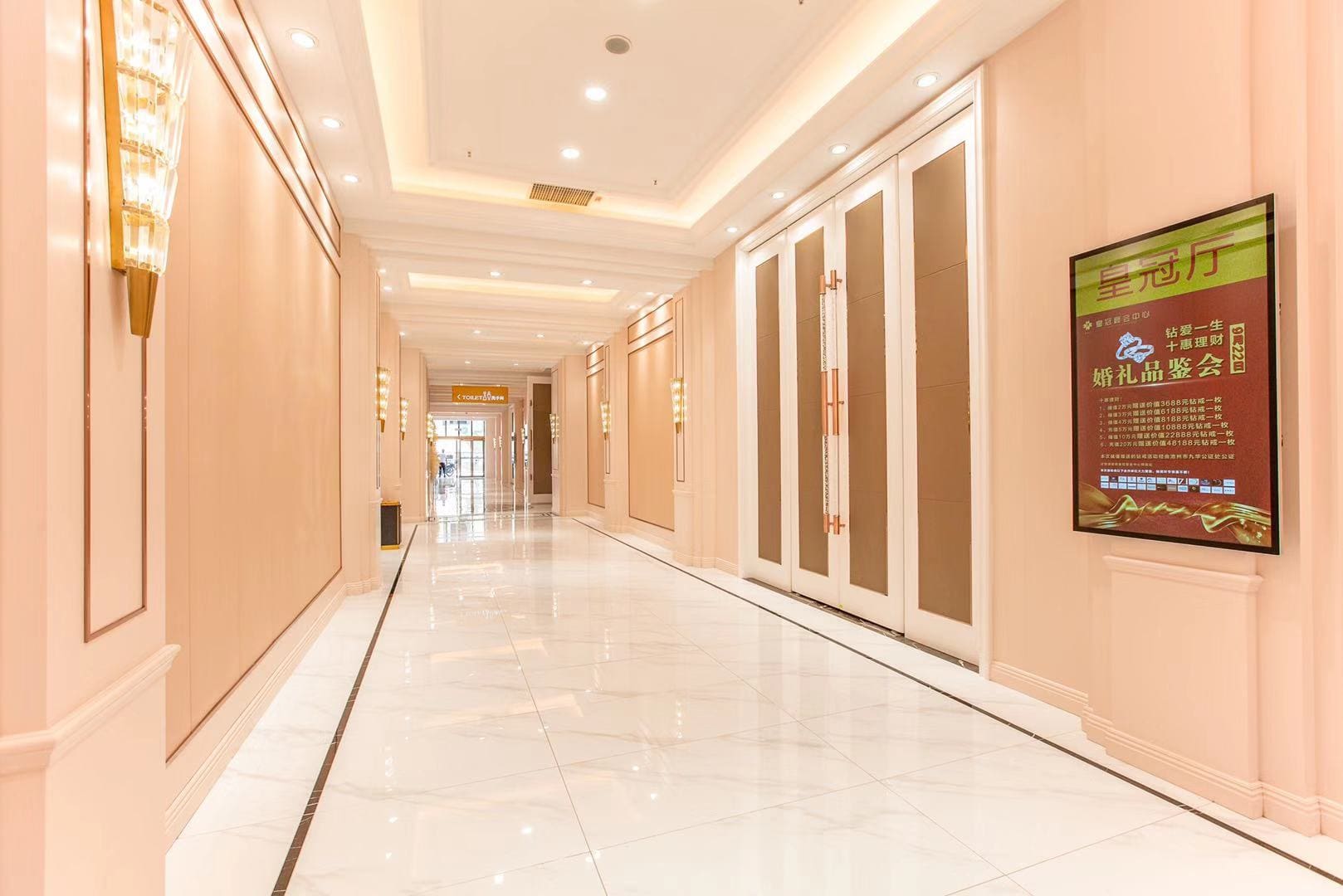 Elegant hotel corridor with bright lighting.